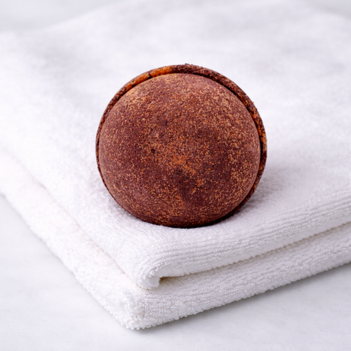 Brown bath bomb on a white towel