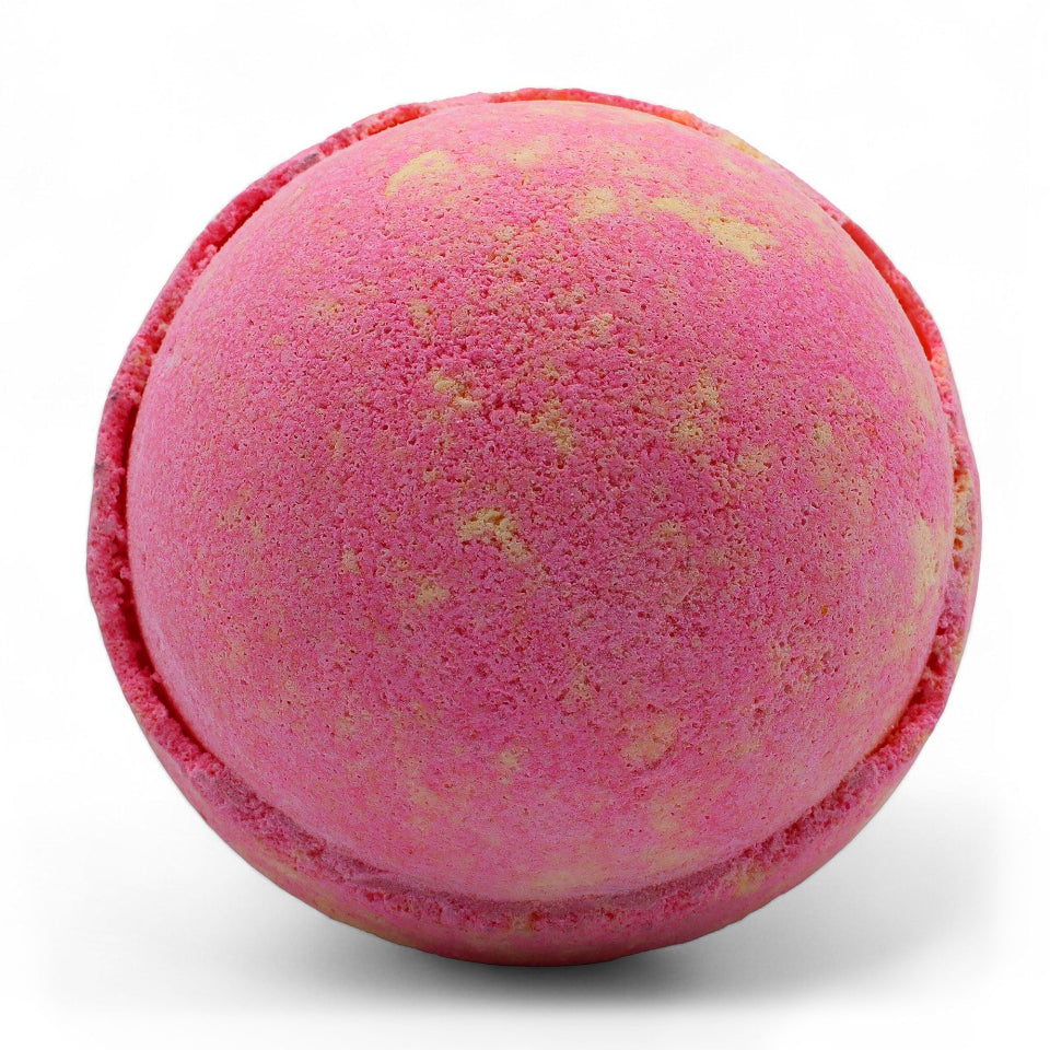 Pink bath bomb with gold specks on a white background